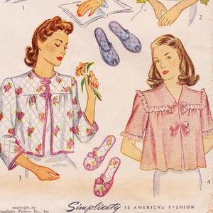 May include: A vintage Simplicity sewing pattern illustration featuring two garments and two pairs of slippers. One garment is a white quilted jacket with pink floral patterns and frog closures. The other is a pink blouse with ruffled trim and bows.