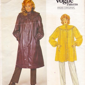 May include: A vintage Vogue Patterns sewing pattern showing two women's fashion designs. One is a long, burgundy coat with a high collar and button closure. The other is a yellow tunic with long sleeves and pockets. The pattern is labelled "PARIS ORIGINAL."