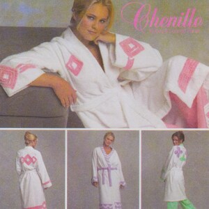 May include: White terry cloth robe with pink geometric detailing on the sleeves and trim. The robe has a matching pink belt. The word "Chenille" is visible in the upper right corner. Several images of the robe are shown.