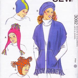 May include: Illustration of a sewing pattern for hats and a shawl. The pattern features four different hat designs: a blue beanie with a yellow stripe, a pink hat with ear flaps and tassels, an orange hat with blue polka dots, and a purple beret. A blue shawl with pockets is also shown.