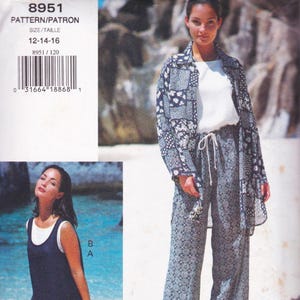 May include: A woman models a three-piece outfit: a white top, patterned pants, and a matching long jacket. The jacket and pants feature a dark blue and white floral design. The image also includes a pattern envelope with the text "8951" and size information.