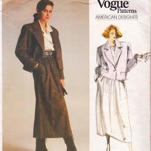 May include: A woman wearing a brown blazer, a cream-colored blouse, and a long brown skirt with a paisley pattern. The skirt is paired with brown boots. The image also features a Vogue Patterns design with the text "AMERICAN DESIGNER."