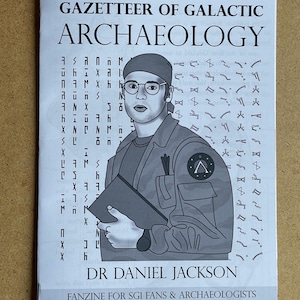 May include: A black and white fanzine titled "Gazetteer of Galactic Archaeology" featuring an illustration of Dr. Daniel Jackson. The cover includes stylized text and symbols, with the tagline "Fanzine for SGI Fans & Archaeologists."