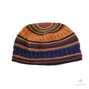 May include: A colorful, crocheted beanie hat. The hat features a striped pattern with shades of orange, blue, green, and red. The top of the hat has a floral design. The hat is made of a soft, textured yarn.