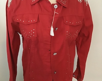 May include: Red denim jacket with silver rhinestone embellishments on the shoulders and around the pockets.