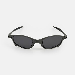 May include: Black sunglasses with a streamlined design. The sunglasses have dark lenses and a matte black frame. The arms are slender and curve gently. The overall style is modern and sporty, suitable for various activities.