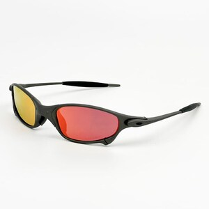 May include: Black sunglasses with a sleek design. The lenses have a yellow to red gradient. The frames are matte black, and the arms curve for comfort. A stylish accessory for eye protection. The sunglasses are suitable for both men and women.