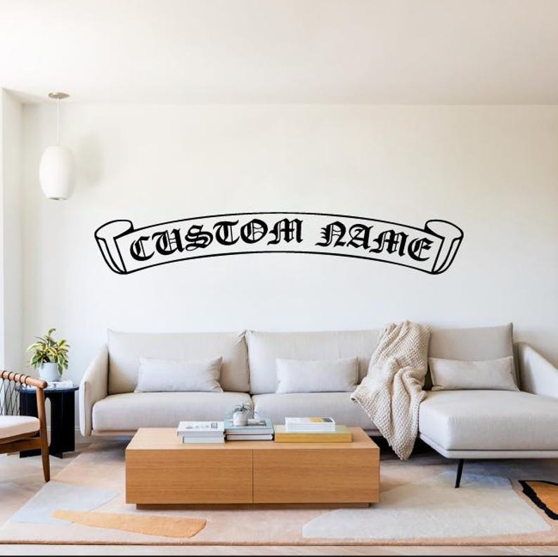 May include: A white sofa with a black and white banner on the wall behind it. The banner says "CUSTOM NAME" in a gothic font.