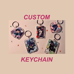 May include: A selection of custom keyrings in heart and rectangular shapes. Each keyring features a photograph and decorative elements such as glitter and flowers. The words "CUSTOM" and "KEYCHAIN" are displayed in pink text.