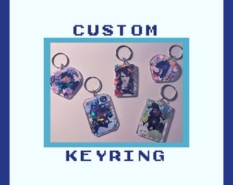May include: Five custom keyrings with metal rings, featuring clear acrylic frames filled with various colorful charms, glitter, and small photographic portraits. The text CUSTOM KEYRING is displayed in a pixelated font above and below the items.