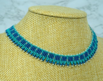 Geometric choker, blue, turquoise and white, beadwoven choker with a button and loop fastening.