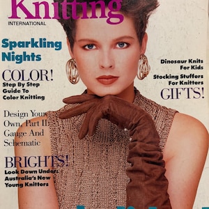 May include: A vintage Vogue Knitting International magazine cover featuring a person with short dark hair wearing a sleeveless brown textured top, large gold hoop earrings, and long brown gloves. The cover text includes Sparkling Nights, Color, and Holiday.