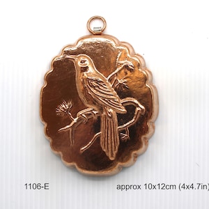 May include: Copper cake mold shaped like a bird perched on a branch. The mold is approximately 10 by 12 inches.