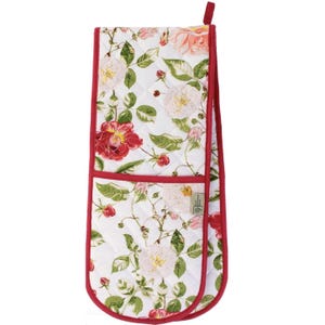May include: A quilted double oven mitt with a floral rose pattern in red, pink, and white. The mitt has a red trim and a loop for hanging. The design features roses, leaves, and berries on a white background.