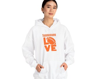 May include: White hooded sweatshirt with the word "Tennessee" above the word "LOVE" in orange block letters. The "O" in "LOVE" is replaced with an orange football. The sweatshirt has a front pocket and a drawstring hood.