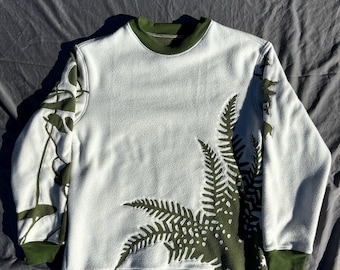 A medium sized green and white plant themed crewneck