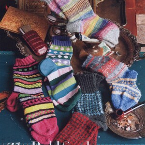 May include: A collection of colorful, knitted socks in various patterns and designs. The socks feature stripes, geometric shapes, and a mix of bright colors like pink, blue, and yellow. The text "The Bold Sock" is visible.
