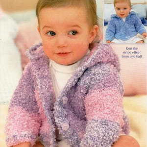 May include: A baby in a hooded, fuzzy knit jacket. The jacket features purple and pink stripes and matching buttons. A smaller inset photo shows a baby in a blue knit jacket. The text reads: "Knit the stripe effect from one ball."