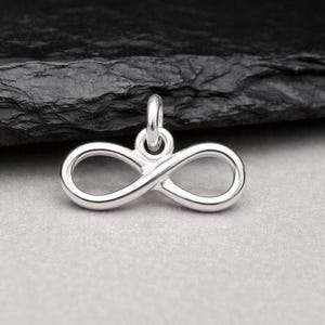 May include: A set of three ceramic mugs with a speckled, matte finish. The mugs are in shades of cream, light gray, and dark gray. Each mug has a simple, modern design and a rounded handle.