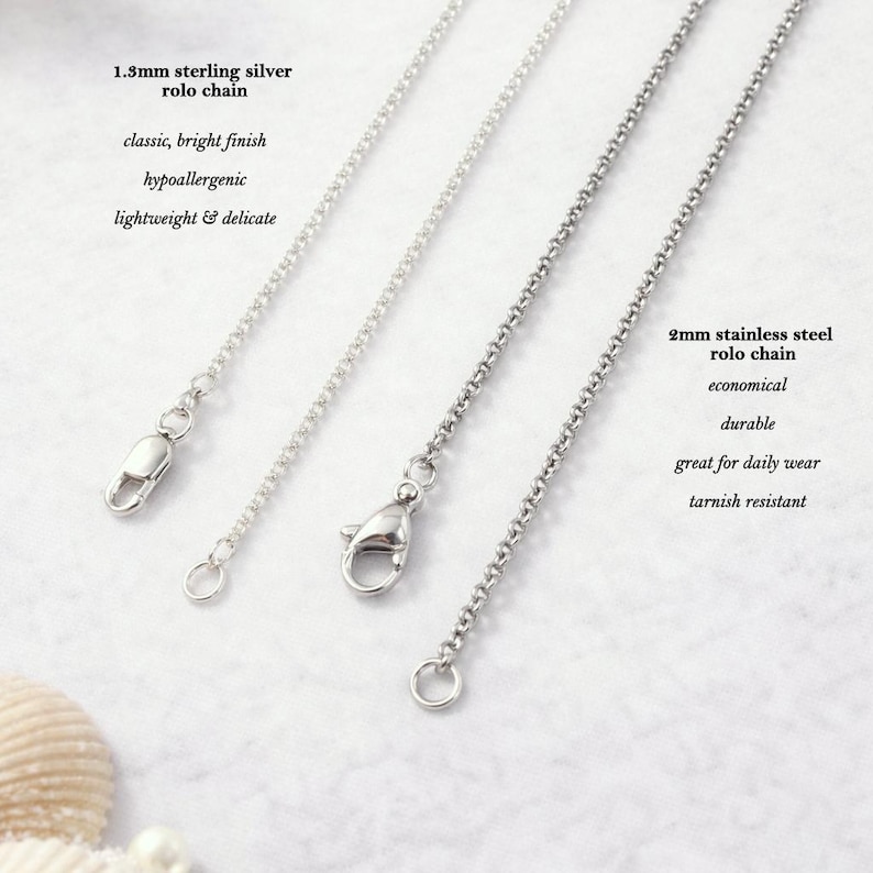 three different types of silver chain necklaces, each with a unique clasp design, arranged side by side.