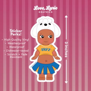 May include: A die-cut sticker featuring a cartoon baby wearing a white hat with black eyes and ears, a yellow shirt with "1922", and a blue skirt. The sticker is 3 inches (7.6 cm) tall. The sticker is high-quality vinyl, weatherproof, waterproof, dishwasher-tested, and scratch and fade resistant.