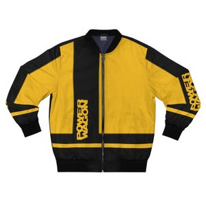 May include: A black and yellow bomber jacket with the text "POWER WAGON" in yellow. The jacket has a zipper closure and black cuffs and hem. The sleeves have the word "POWER" in yellow.