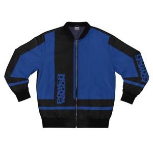 May include: A blue and black bomber jacket with the text "POWER WAGON" printed vertically on the front and on the left sleeve. The jacket has a black zipper and black cuffs.