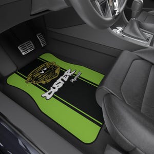 May include: Green and black car floor mats with a cartoon character and the text "Buster Plymouth".