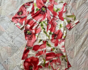 May include: A short-sleeved button-down shirt with a vibrant floral pattern. The shirt features large red poppies with green leaves against a white background. The label "DOLCE&GABBANA" is visible at the collar.