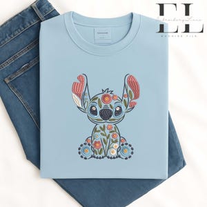 Floral Stitch embroidery design, cute Stitch sitting with colorful flower patterns, pastel Disney embroidery style