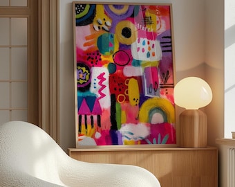 May include: A rectangular framed wall art print featuring a vibrant abstract composition with bold splashes of hot pink, bright yellow, deep purple, and teal. The artwork displays various geometric shapes, including circles, triangles, and arches, alongside textured brushstrokes and scattered dots, all contained within a light-toned wooden frame.