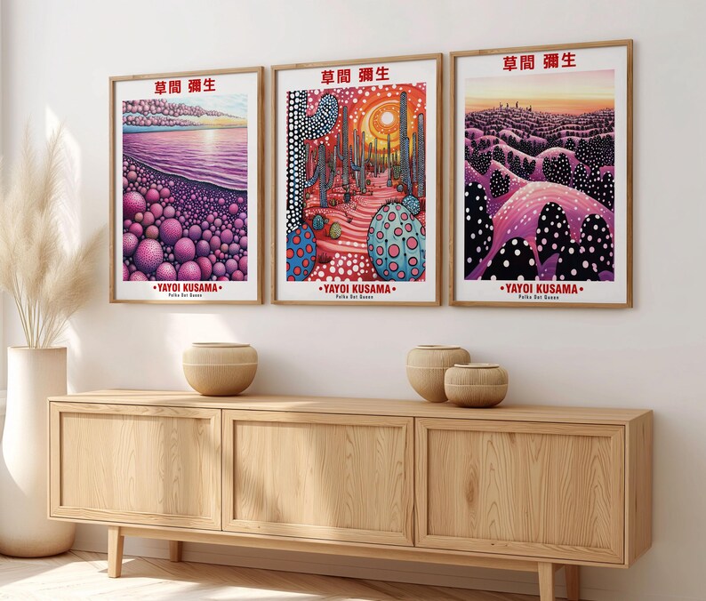 May include: Three framed art prints featuring colorful, abstract landscapes. Each print has a wooden frame and includes the text "草間彌生" and "YAYOI KUSAMA". The artwork depicts scenes with vibrant colors and dotted patterns.
