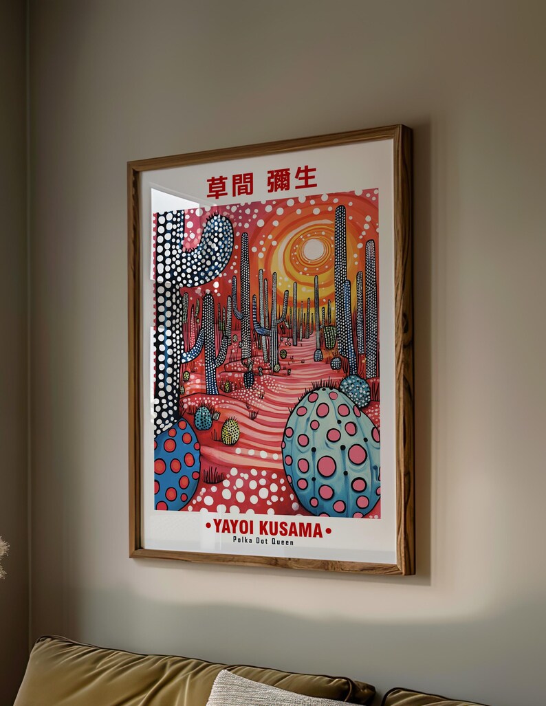 May include: A framed art print featuring a desert landscape with stylized cacti and a vibrant color palette. The artwork includes the text "YAYOI KUSAMA" and "Polka Dot Queen". The print is in a wooden frame.