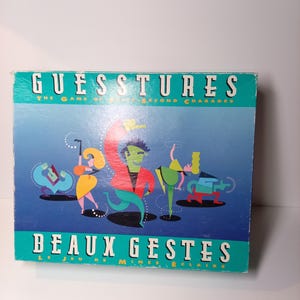 May include: A rectangular board game box titled Guesstures The Game of Split-Second Charades and Beaux Gestes Le Jeu de Mimes Éclairs. The blue box features stylised, colourful illustrations of four figures in various poses against a gradient background.