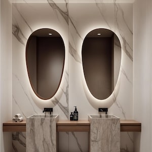 Reflect your style with Modern LED mirror, which is the perfect decorative option for your bedroom. The asymmetric wall mirror with LED lighting offers a stylish design for modern bathrooms and vanity areas.