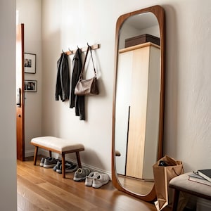 The vanity floor mirror will add a modern atmosphere to your spaces.
The abstract mirror with wood frame is ideal for creating a simple yet impressive atmosphere.