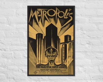 May include: A black and gold poster for the 1927 film "Metropolis" by Fritz Lang. The poster features a stylized image of a futuristic city with a robot woman in the foreground. The text on the poster reads "Metropolis", "Ein Film von Fritz Lang", and "UFA Film im Verleih der", with the names of the actors and the music composer.