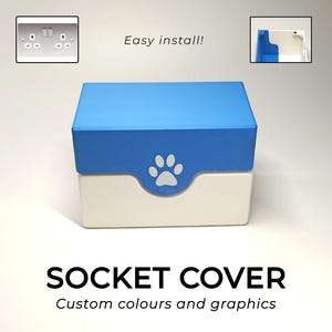 May include: A two-tone socket cover with a blue top and white base, featuring a paw print design. The text "SOCKET COVER" and "Custom colours and graphics" are displayed below the cover. The image also includes a close-up of a socket and the text "Easy install!"