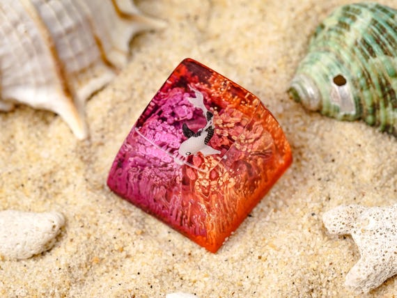 A koi fish swimming in a resin keycap — the layered depth effect makes it look like a tiny living pond sitting on your keyboard.