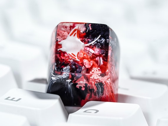A tiny hand-cast resin manta ray that replaces one keycap and turns your whole keyboard into a conversation piece.