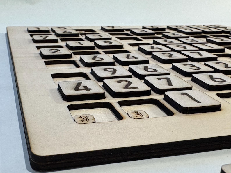 May include: A wooden game board with a grid of numbered squares. The numbers 1 through 9 are visible on the squares.