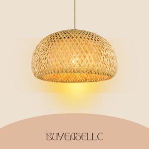 May include: A woven bamboo pendant light. The light has a rounded, dome shape with a lattice design. It is suspended from a natural fibre cord. The light emits a warm, yellow glow. The text "BUYENSELLC" is at the bottom.