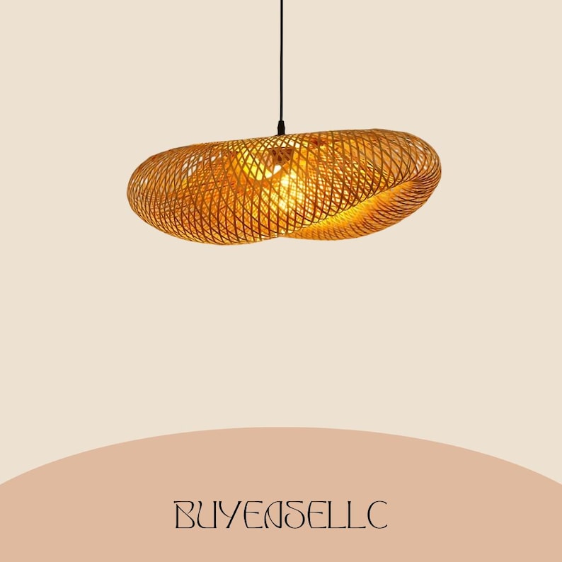 May include: A woven, oval-shaped pendant light fixture. The light is made of a golden-brown material, with a lattice design that allows light to filter through. The fixture hangs from a black cord against a neutral background. The text "BUYENSELLC" is at the bottom.