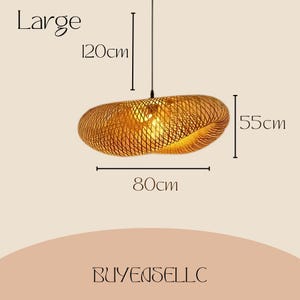 May include: Large, woven pendant light fixture. The fixture is 80cm wide, 55cm high, and hangs down 120cm. The light is made of a natural, golden-brown material and has a unique, organic shape. The text "Large" is above the light.