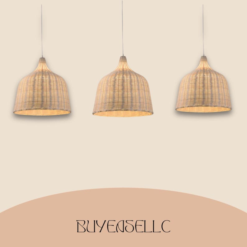May include: Three woven pendant lights with a natural, light beige color. The lamps have a bell-shaped design and hang from thin cords. The text "BUYENSELLC" is at the bottom of the image.