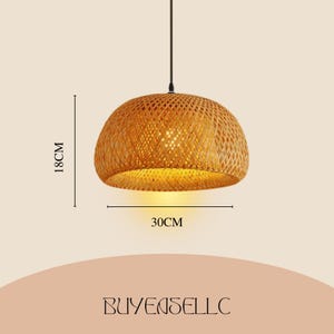 May include: A woven bamboo pendant light. The light fitting is a warm, natural colour, with a diameter of 30 cm and a height of 18 cm. It hangs from a black cord. The light is a dome shape.