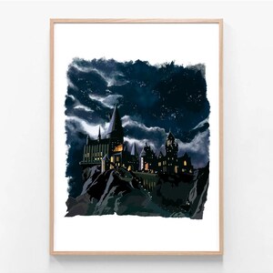 May include: A framed art print featuring a dark, dramatic illustration of a castle under a stormy night sky. The castle is silhouetted against the dark sky, with lights illuminating the windows and pathways. The artwork is framed in a light-colored wooden frame.