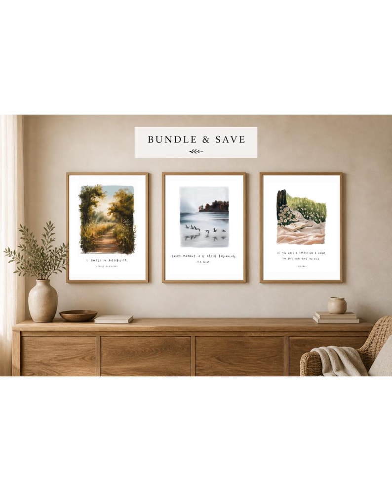 May include: Three framed art prints with nature scenes and inspirational quotes. The prints are displayed on a wooden cabinet. The top print shows a path through a forest, the middle print shows birds flying over water, and the bottom print shows a coastal scene.