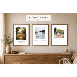 May include: Three framed art prints with nature scenes and inspirational quotes. The prints are displayed on a wooden cabinet. The top print shows a path through a forest, the middle print shows birds flying over water, and the bottom print shows a coastal scene.