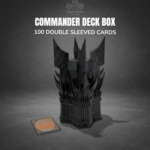 May include: Black Commander Deck Box with a castle-like design, holding 100 double-sleeved cards. The box is next to a Magic: The Gathering card. The text on the box reads "Commander Deck Box" and "100 Double Sleeved Cards".
